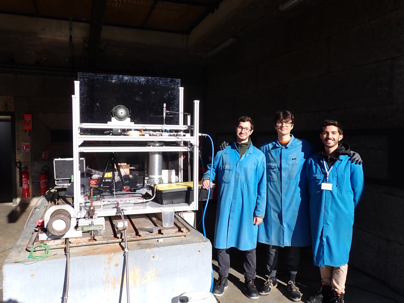 Team posing with the feed system hardware